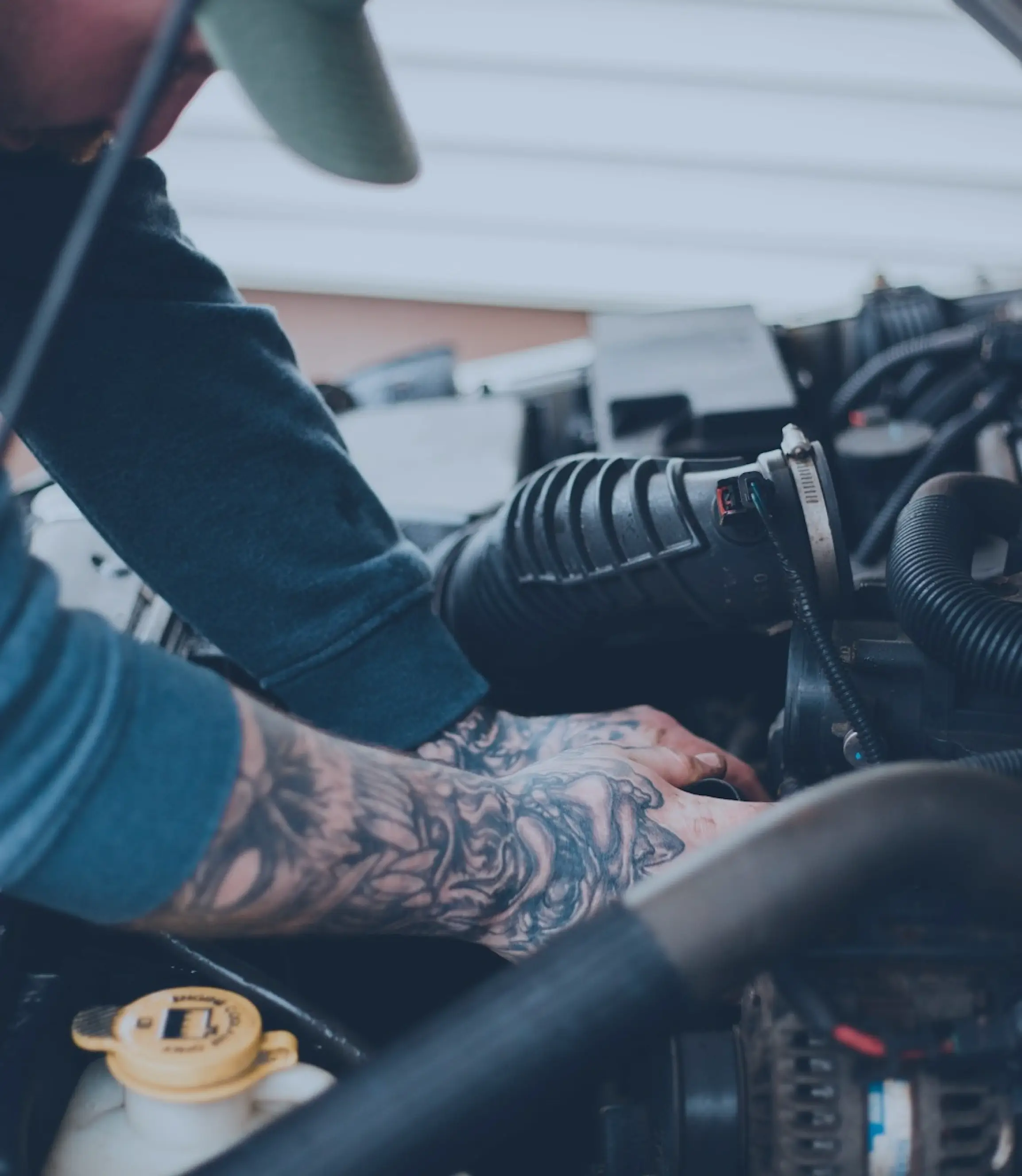 Mechanic repairing a car at The Tire Squad auto repair shop